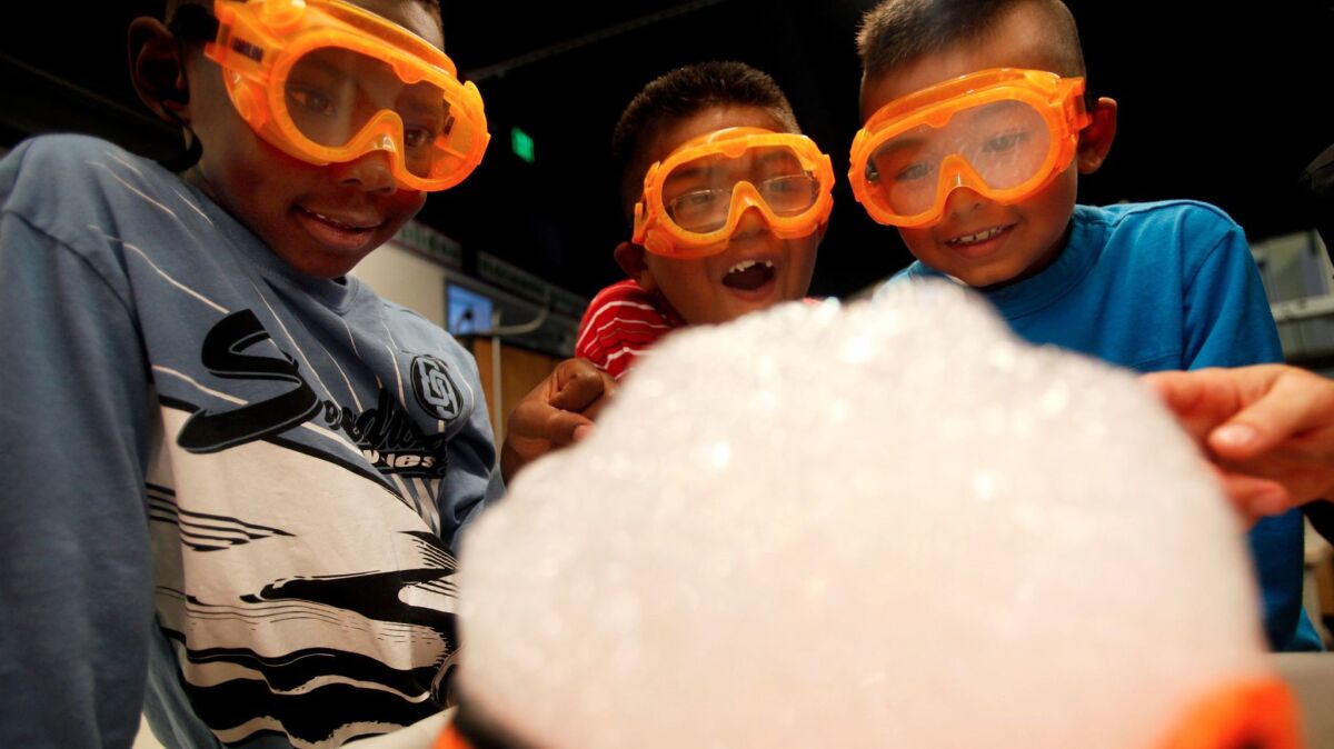 Jestin Banks, Jacob Campo and Marvin Garcia Jr. conduct a science experiment in a first-grade class at Alexander Science Center School in Los Angeles in 2011. Science classes statewide are changing to be more hands-on.