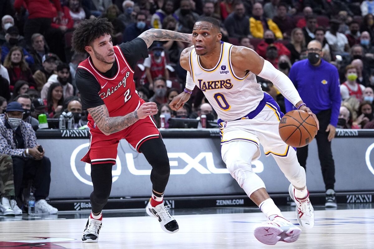  Lakers guard Russell Westbrook, right, drive to the basket against Chicago Bulls guard Lonzo Ball.