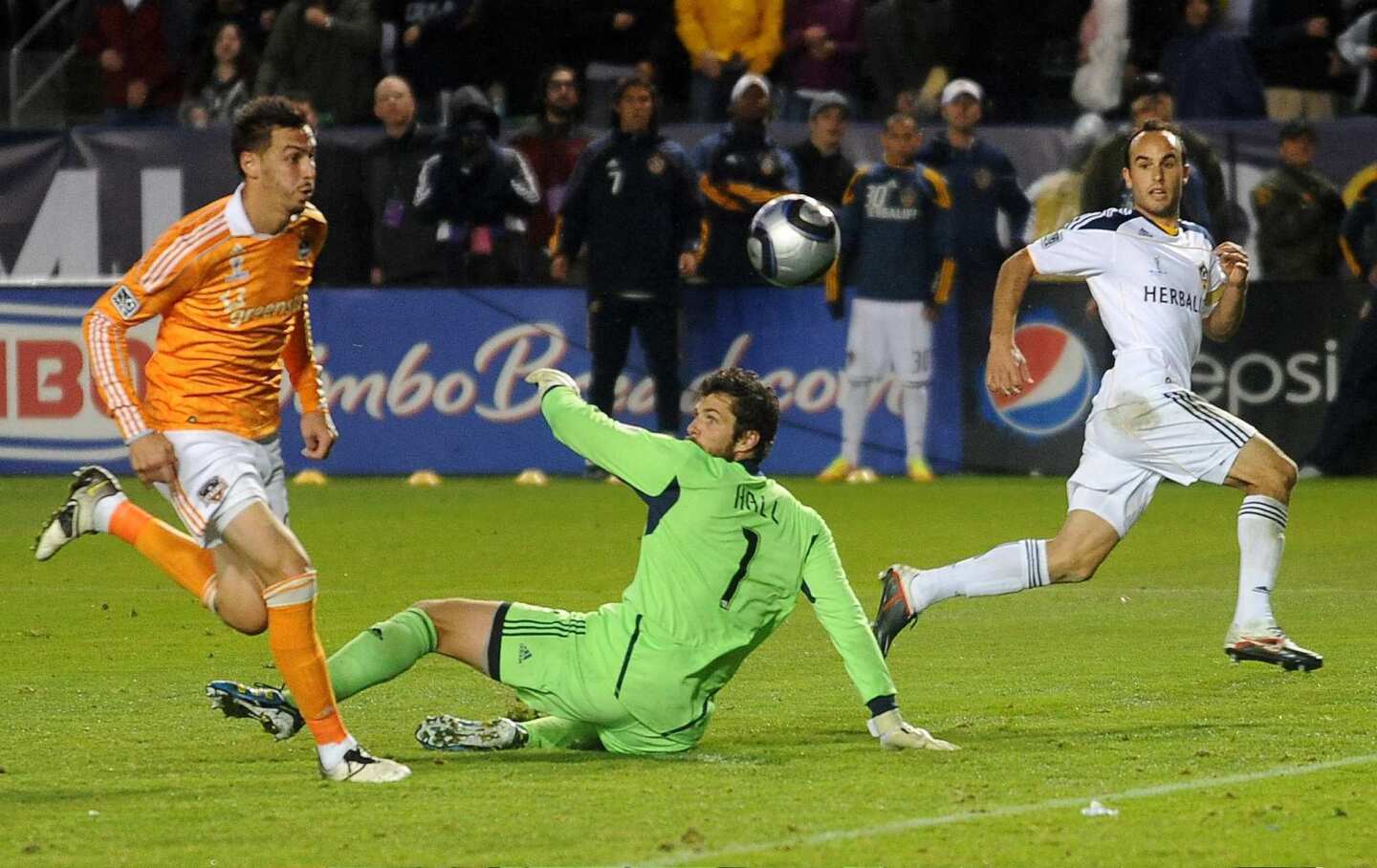 Galaxy midfielder Landon Donovan shoots the ball over Dynamo goalie Tally Hall to score the game-winning goal in the MLS Championship at the Home Depot Center in November. AEG owns both teams.