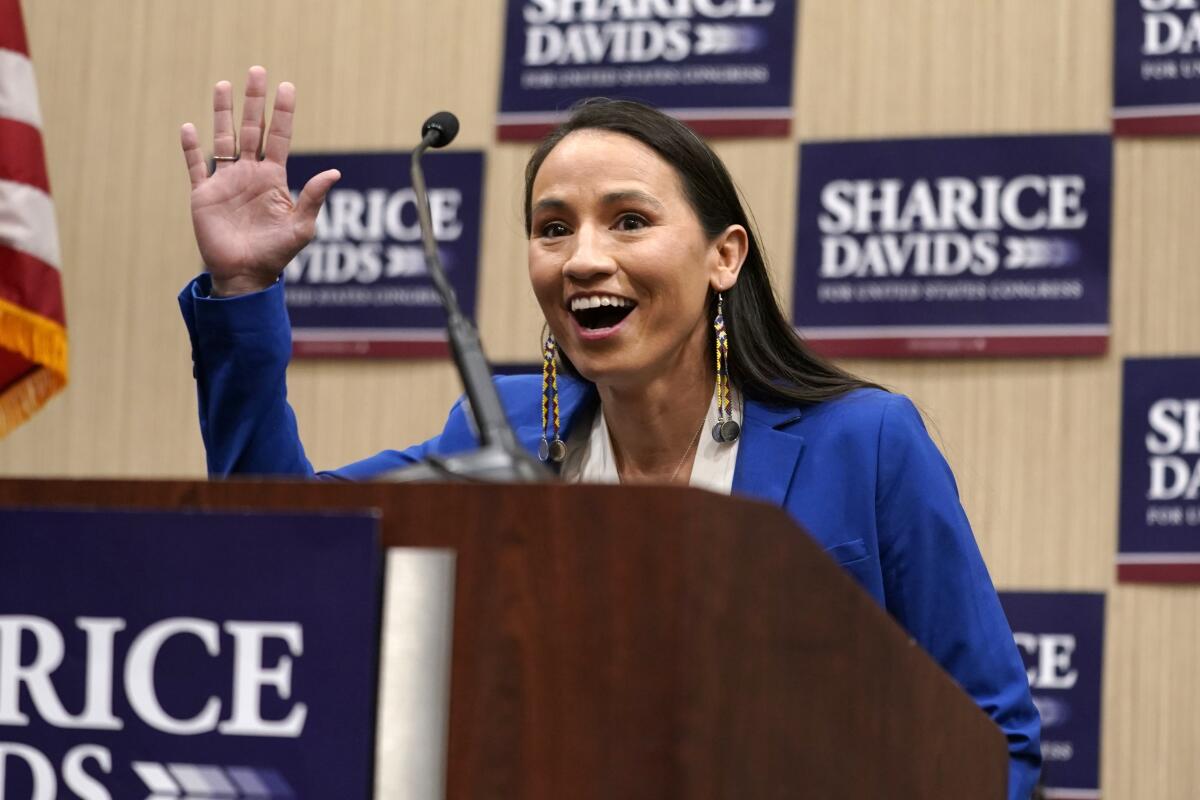 Rep. Sharice Davids, D-Kan., waves to supporters as she takes to the stage at a watch party Tuesday, Nov. 8, 2022, in Overland Park, Kan. Davids defeated Republican candidate Amanda Adkins for the Kansas' 3rd Congressional District seat. (AP Photo/Ed Zurga)