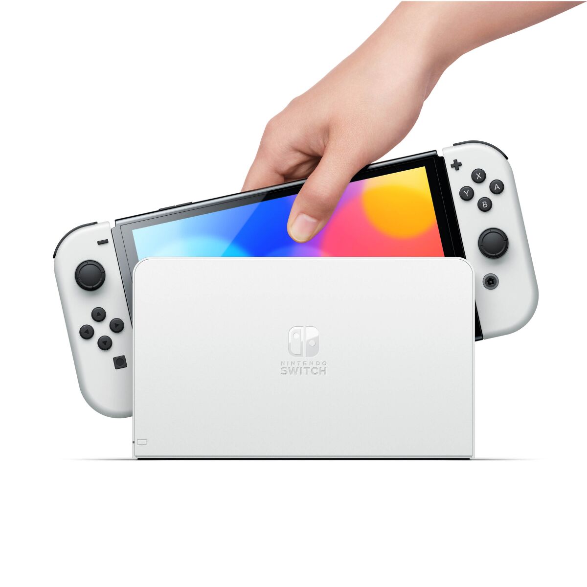 A hand lifts a Nintendo Switch out of its dock.