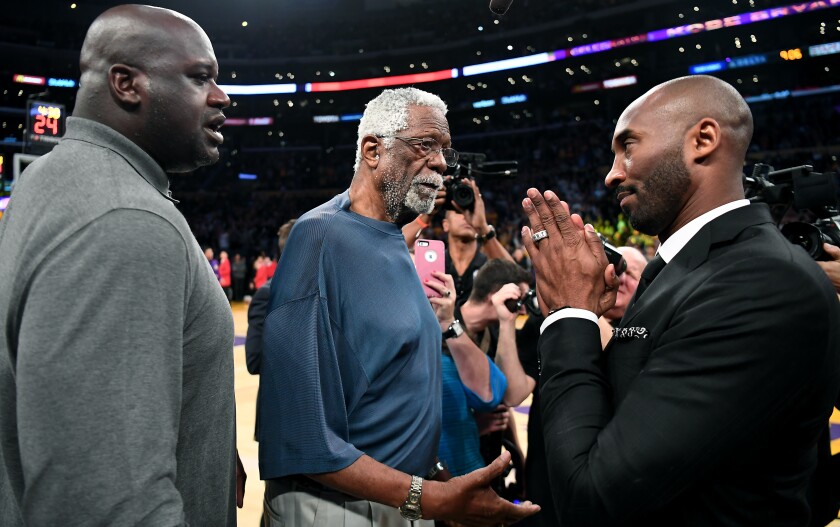 Kobe Bryant chats with Bill Russell as Shaquille O'Neal looks on.
