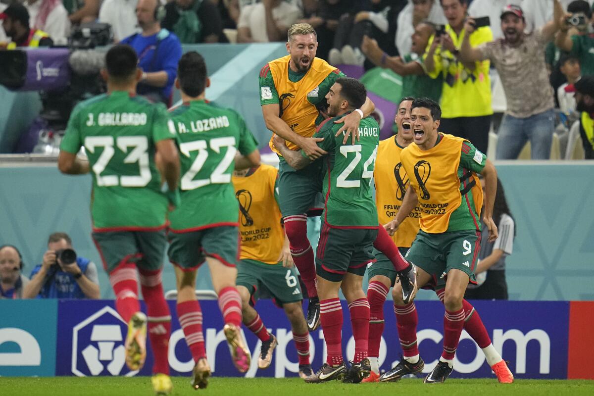 Mexico's Luis Chavez celebrates with teammates after scoring a goal against Saudi Arabia.