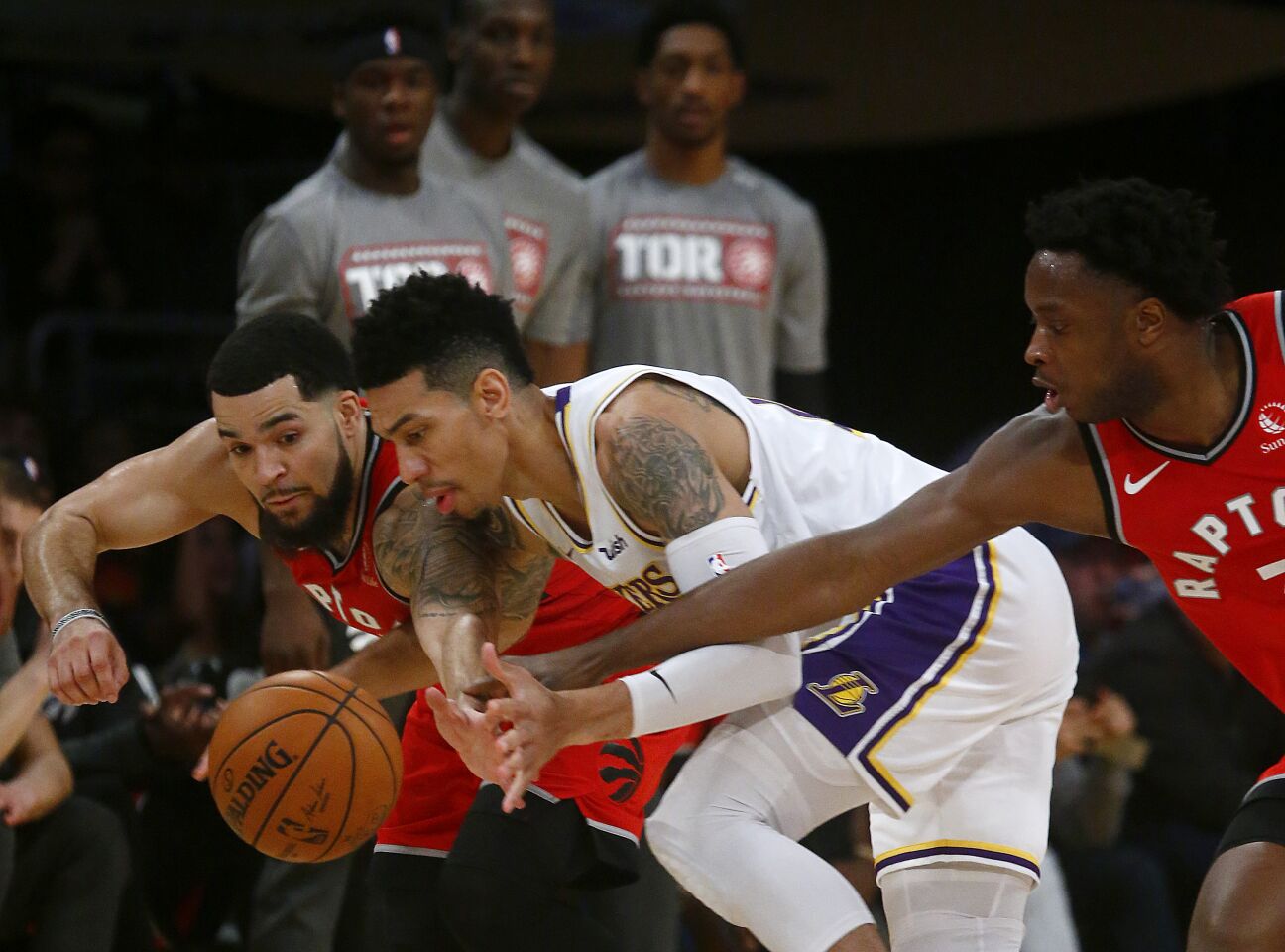 Lakers guard Danny Green, center, fights for a loose ball with Toronto's Fred VanVleet, left, and OG Anunoby during the third quarter.
