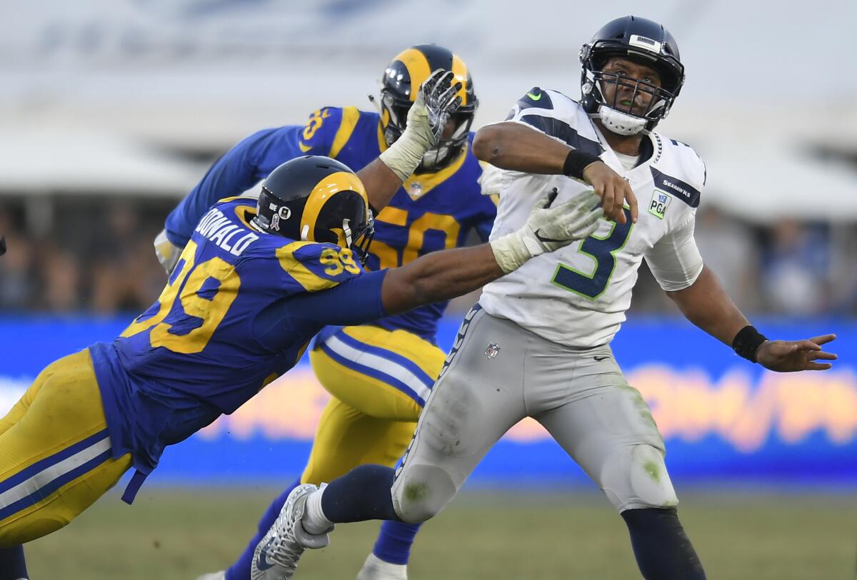 Seattle's Russell Wilson gets off a pass before the Rams' Aaron Donald can tackle the quarterback in an NFC West battle last season.