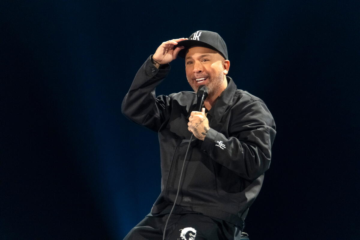 Jo Koy adjusts his baseball hat