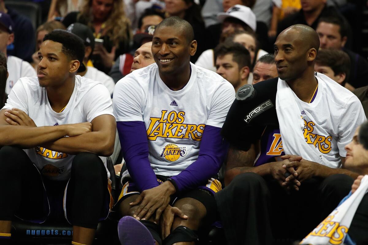 Kobe Bryant, right, and Metta World Peace watch from the bench as the Lakers play Denver on March 2.