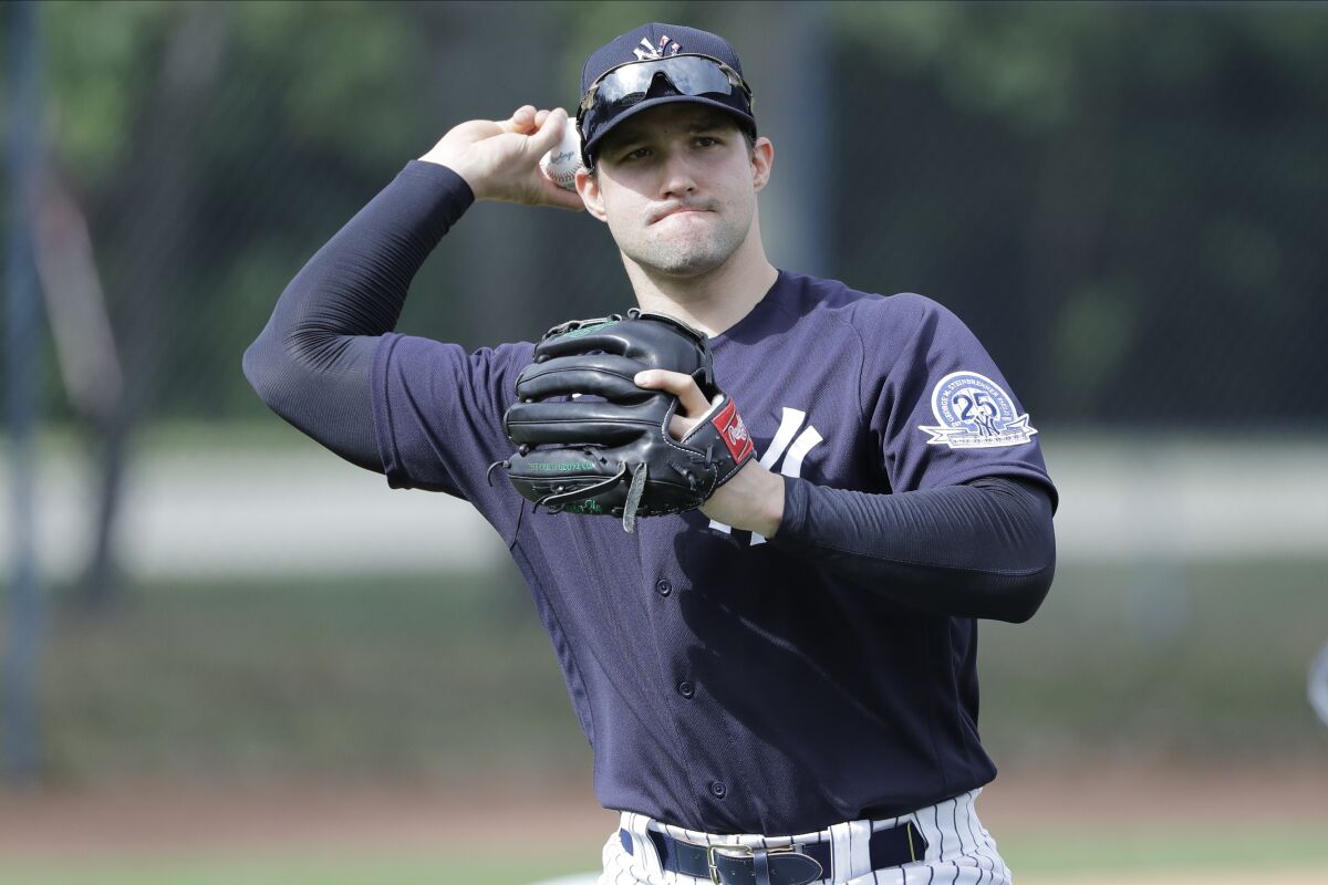 Tommy Kahnle warms up  while wearing a New York Yankees uniform. 