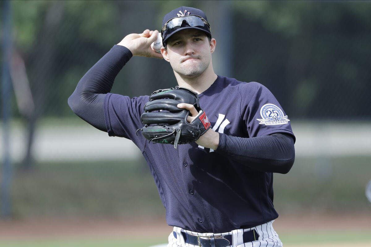 Tommy Kahnle warms up while wearing a New York Yankees uniform.