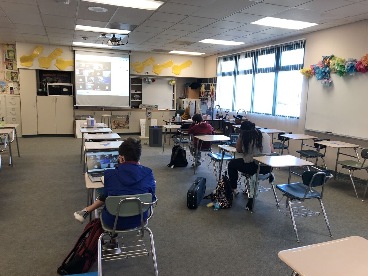 Students in a classroom at Carmel Valley Middle School on the first day return to school.