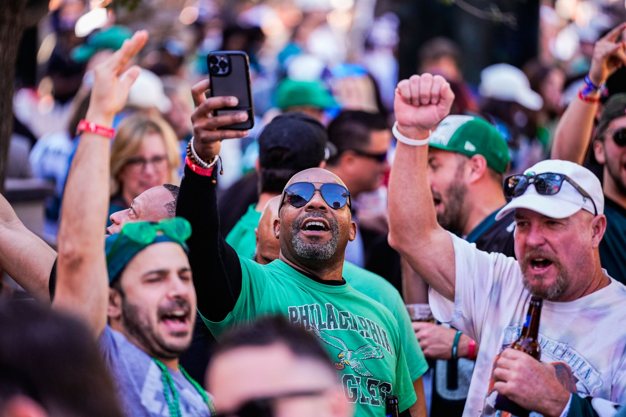 Eagles fans take selfies and gather outside McFadden's Restaurant and Saloon ahead of the Super Bowl.