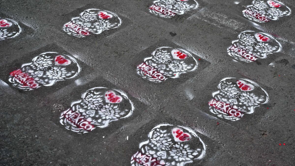 Skull stencils bearing the number 43 line the street in front of the National Palace in Mexico City in late August at a rally in support of the parents of the missing students.