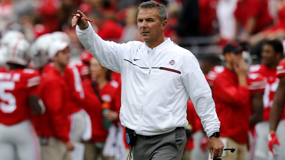 Ohio State Coach Urban Meyer gives instructions to his players during a win over Rutgers on Saturday.