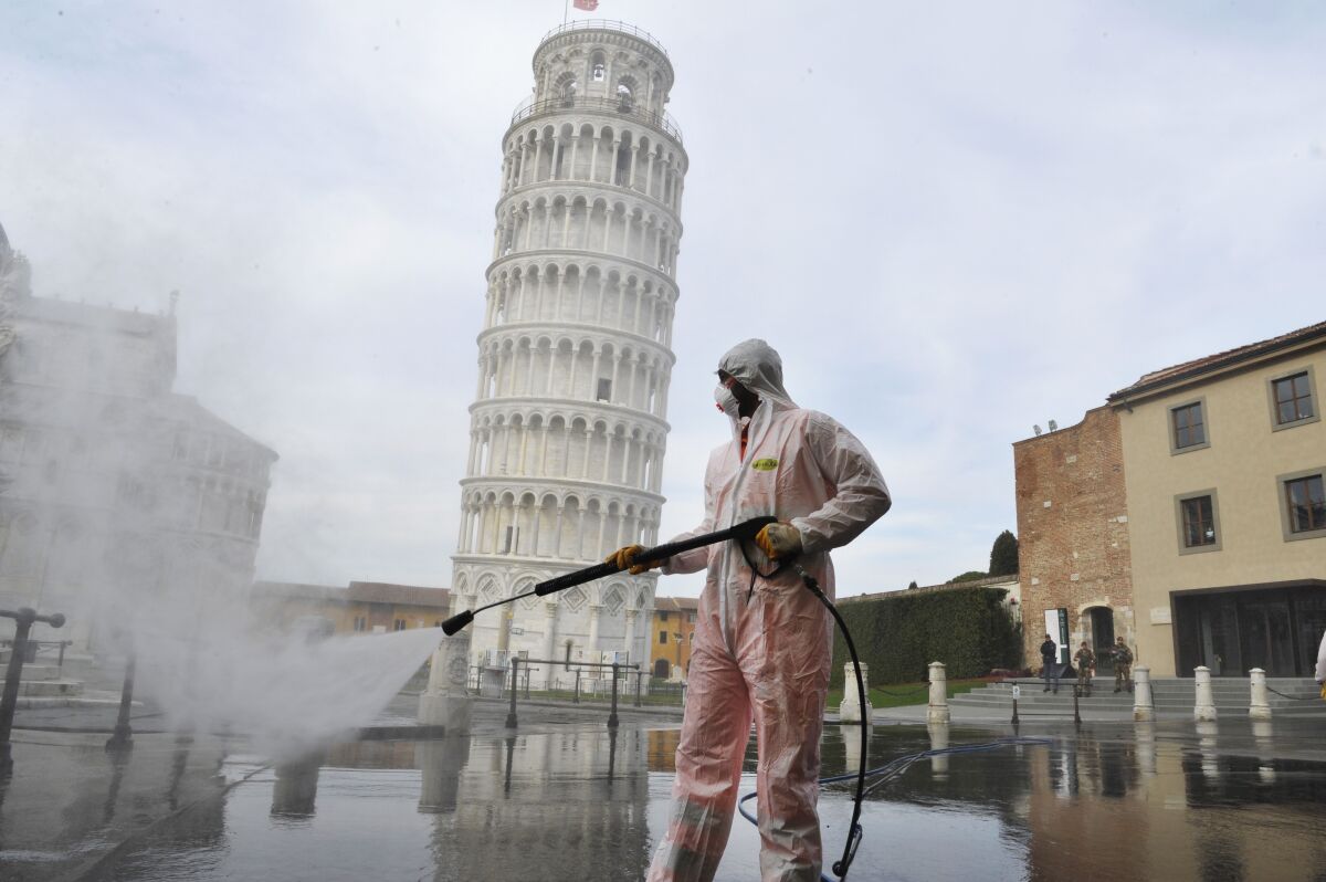 A worker carries out sanitation operations in Piazza dei Miracoli near the Tower of Pisa on March 17.