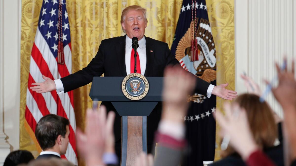 Reporters raise their hands as President Donald Trump fields questions during a news conference in the East Room of the White House in Washington on Feb. 16.