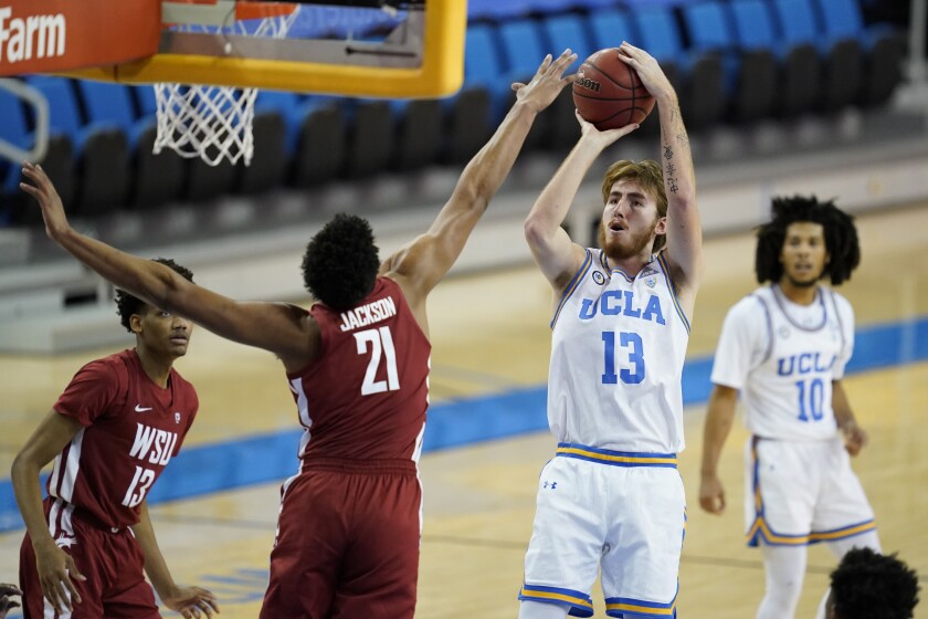 UCLA guard Jake Kyman takes a shot against Washington State center Dishon Jackson.