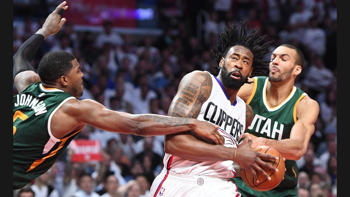 Clippers center DeAndre Jordan is fouled by Utah Jazz center Rudy Gobert as Joe Johnson helps on defense during Game 5 of their Western Conference playoff series at Staples Center on April 25.