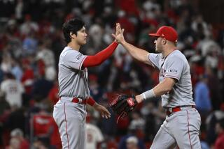 Los Angeles Angels' Shohei Ohtani, left, and teammate Mike Trout, right, celebrate their team's 6-4 victory over the St. Louis Cardinals in a baseball game on Wednesday May 3, 2023, in St. Louis. (AP Photo/Joe Puetz)