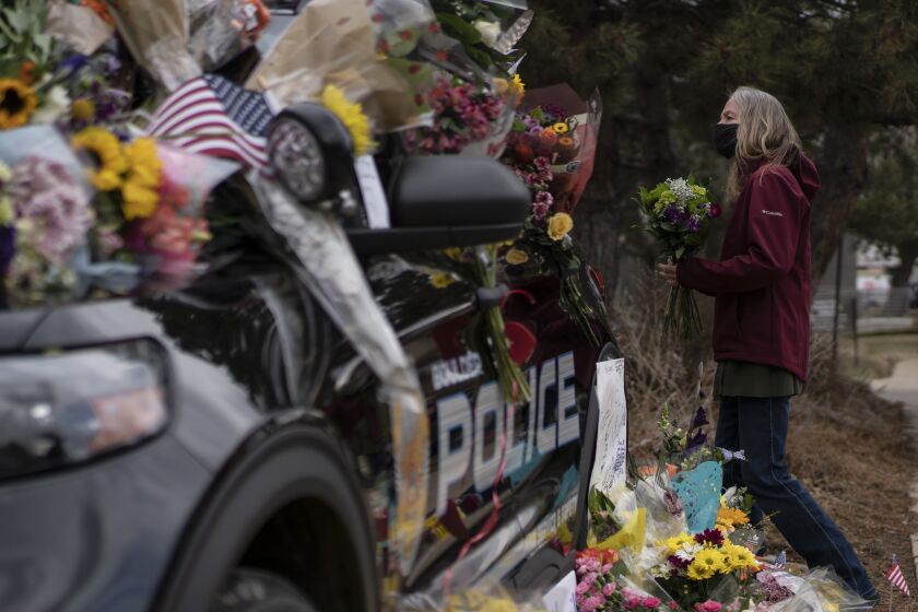 BOULDER, CO - MARCH 23: Mourners pay their respects to Officer Eric Talley, who was killed after a gunman opened fire at a King Sooper's grocery store on March 23, 2021 in Boulder, Colorado. Ten people were killed in the attack. (Photo by Chet Strange/Getty Images)