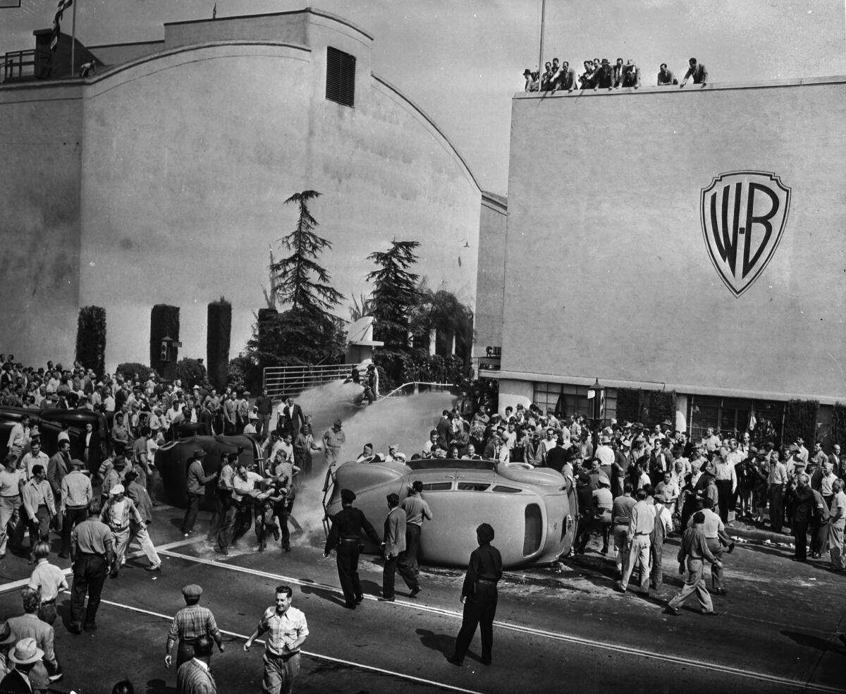 On Oct. 5, 1945, strikers outside of Warner Bros. Studios in Burbank flee as studio firemen turn hoses toward them.