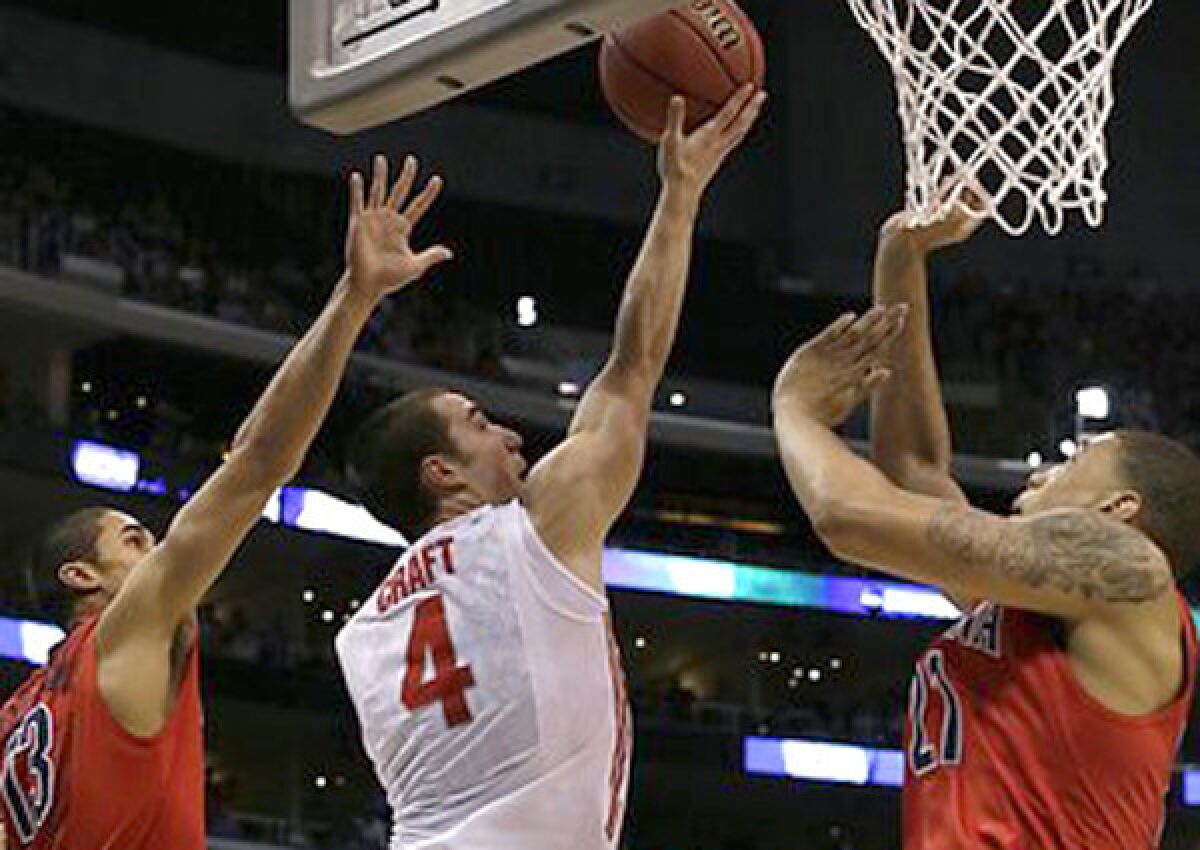 Ohio State guard Aaron Crafts splits two Arizona defenders for a basket in the first half Thursday night.