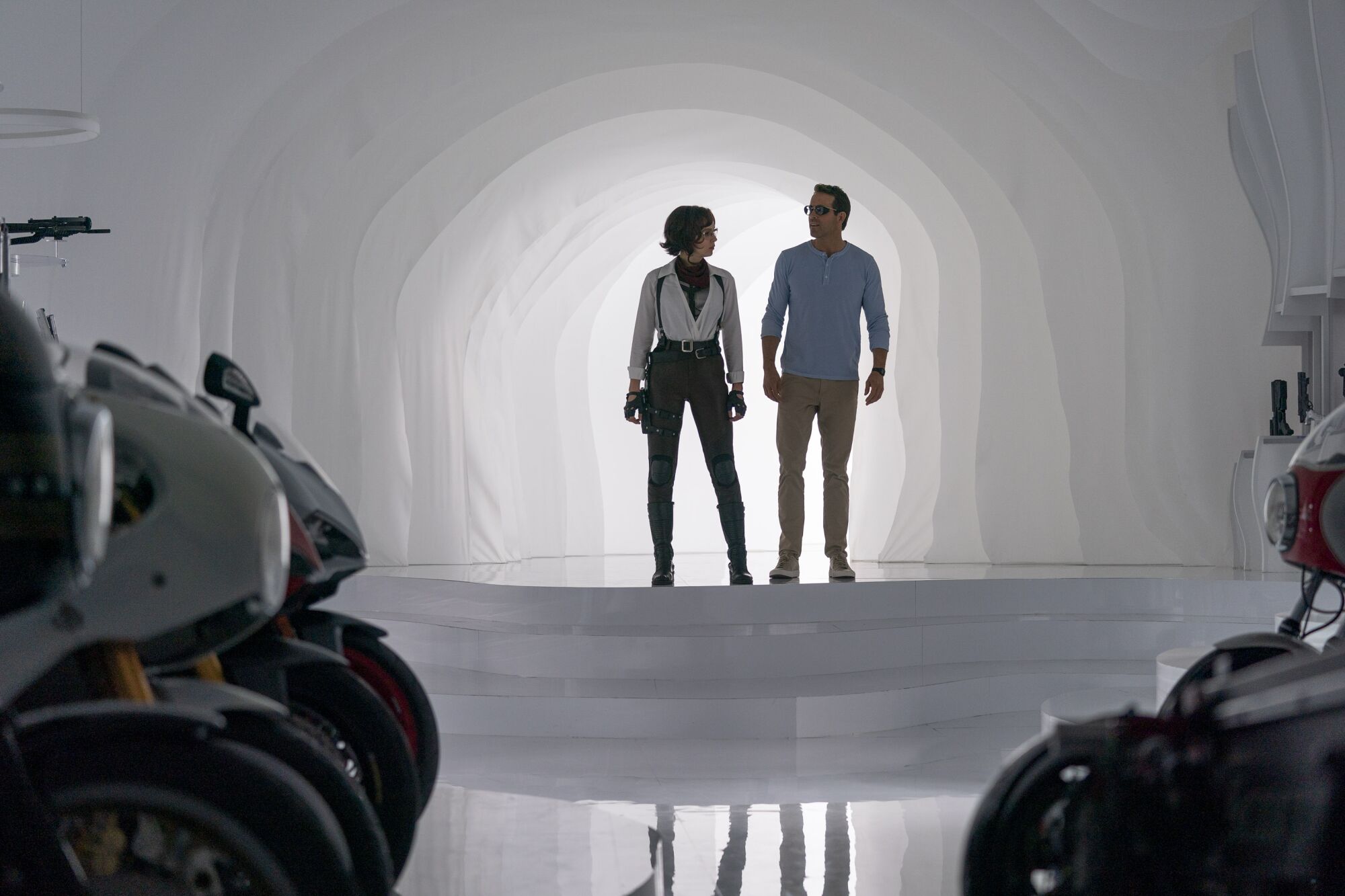 A man and a woman stand in front of a tunnel of light.