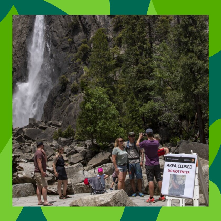 Visitors to Yosemite Valley take photos at Lower Yosemite Fall.