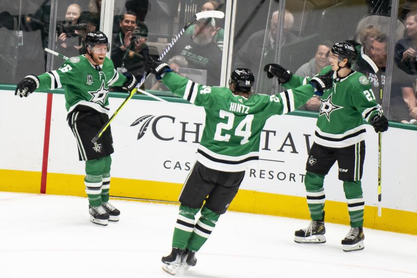 FILE - From left to right, Dallas Stars center Joe Pavelski (16) cheers after scoring a goal alongside center Roope Hintz (24) and left wing Jason Robertson (21) during an NHL hockey game against the Colorado Avalanche, March 4, 2023, in Dallas. Robertson, Hintz and seemingly ageless 39-year-old Pavelski are going into their third season together as the Stars' top scoring line. (AP Photo/Emil T. Lippe, File)