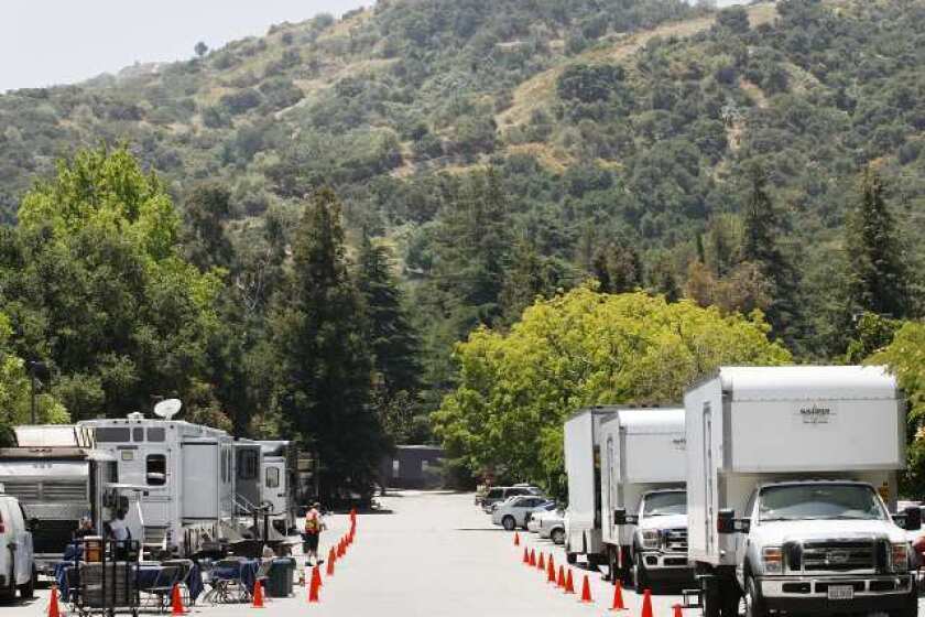 A caravan of production vehicles line up in the parking lot at Descanso Gardens in La Canada Flintridge for the filming of a McDonald's commercial.