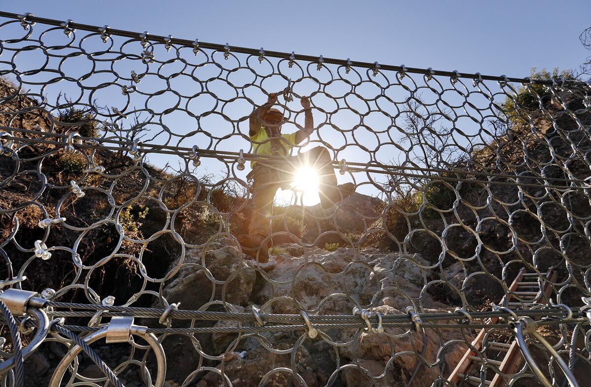 Jon Simpson installs one of five debris-flow barriers on Conejo Mountain in December 2015.
