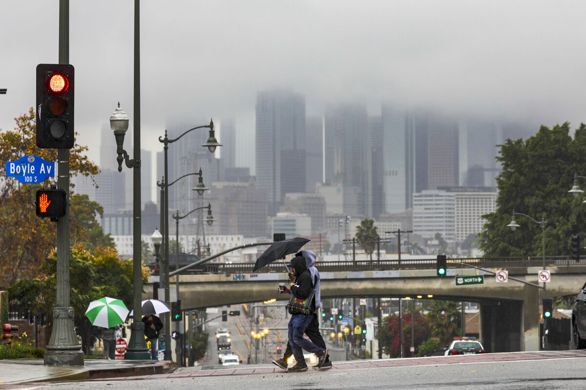 Los Angeles skyline shrouded in clouds on Wednesday during steady rain