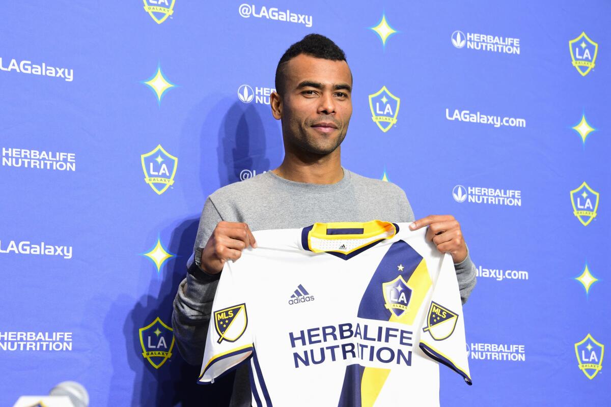 New Los Angeles Galaxy's player, English footballer Ashley Cole shows his LA Galaxy jersey at a news conference at the StubHub Center.
