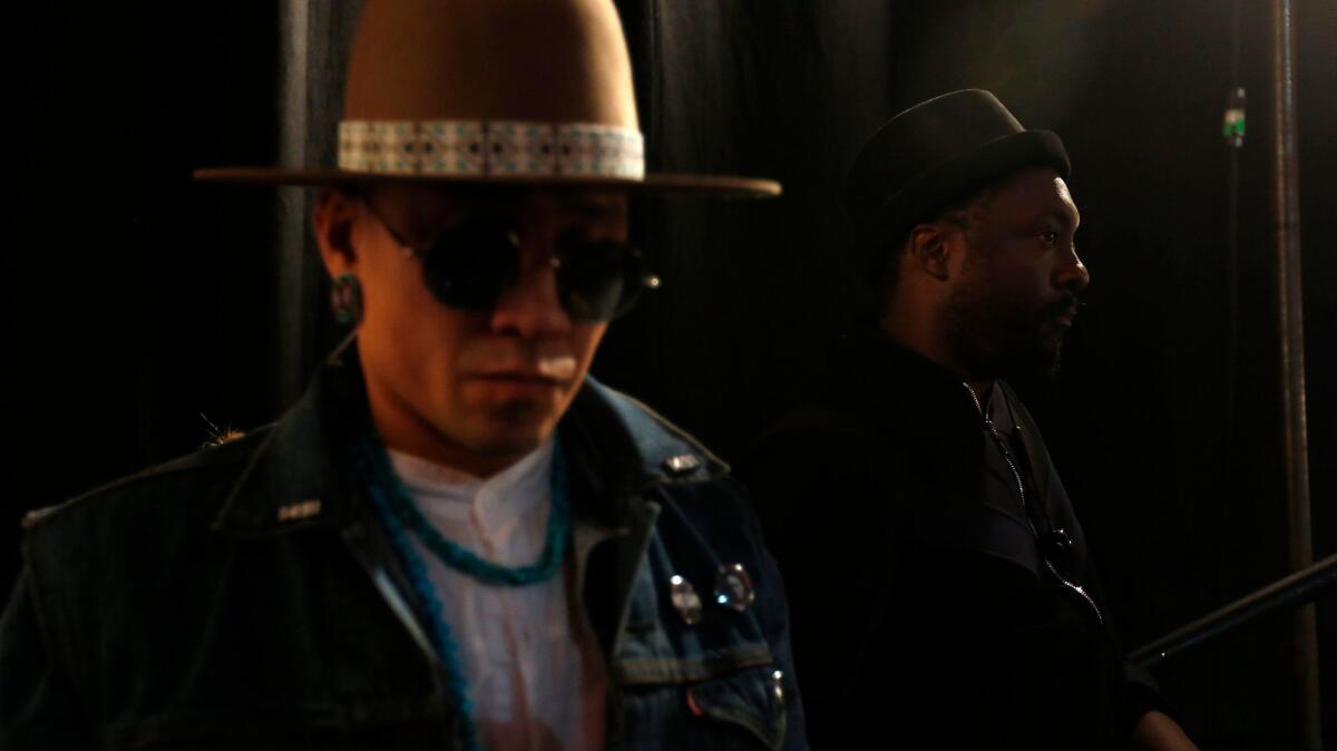 Taboo, left, and will.i.am, both of The Black Eyed Peas, wait for the premiere of their new video, "Street Livin"