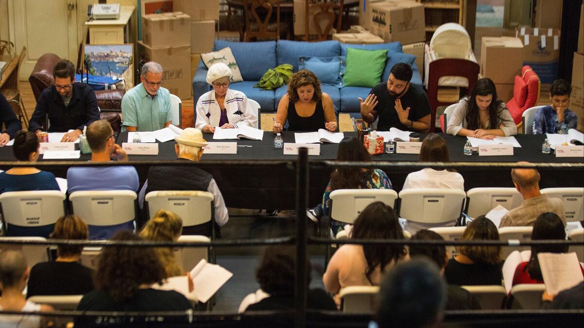 "One Day at a Time" writers, cast and crew members assemble on a sound stage at Sony Pictures Studios for a table reading of an upcoming episode in Culver City, Calif., on Aug. 2, 2017.