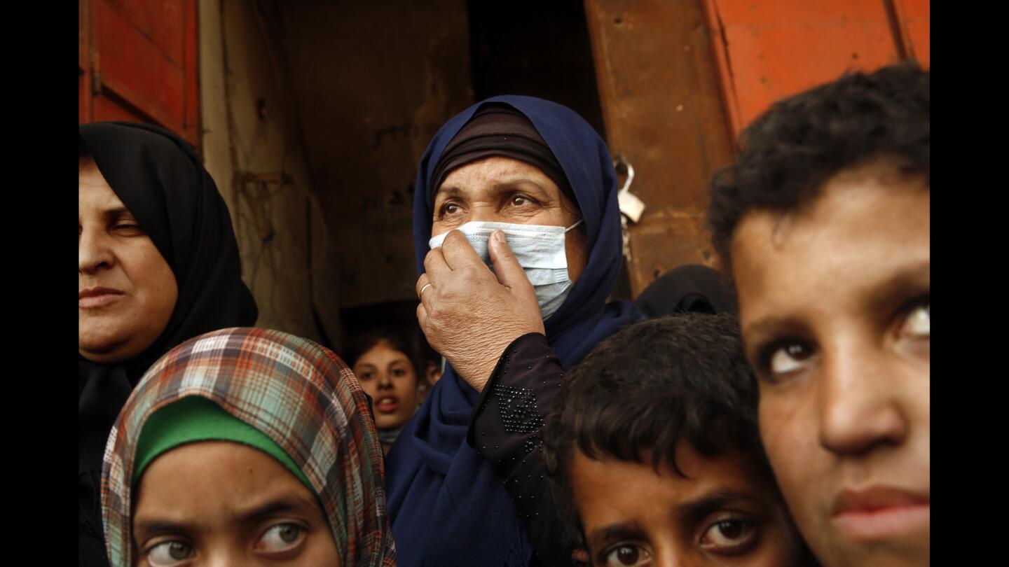 Batul Khalil, 60, is having breathing problems with all of the smoke and chemicals in the air in her town of Qayyarah.