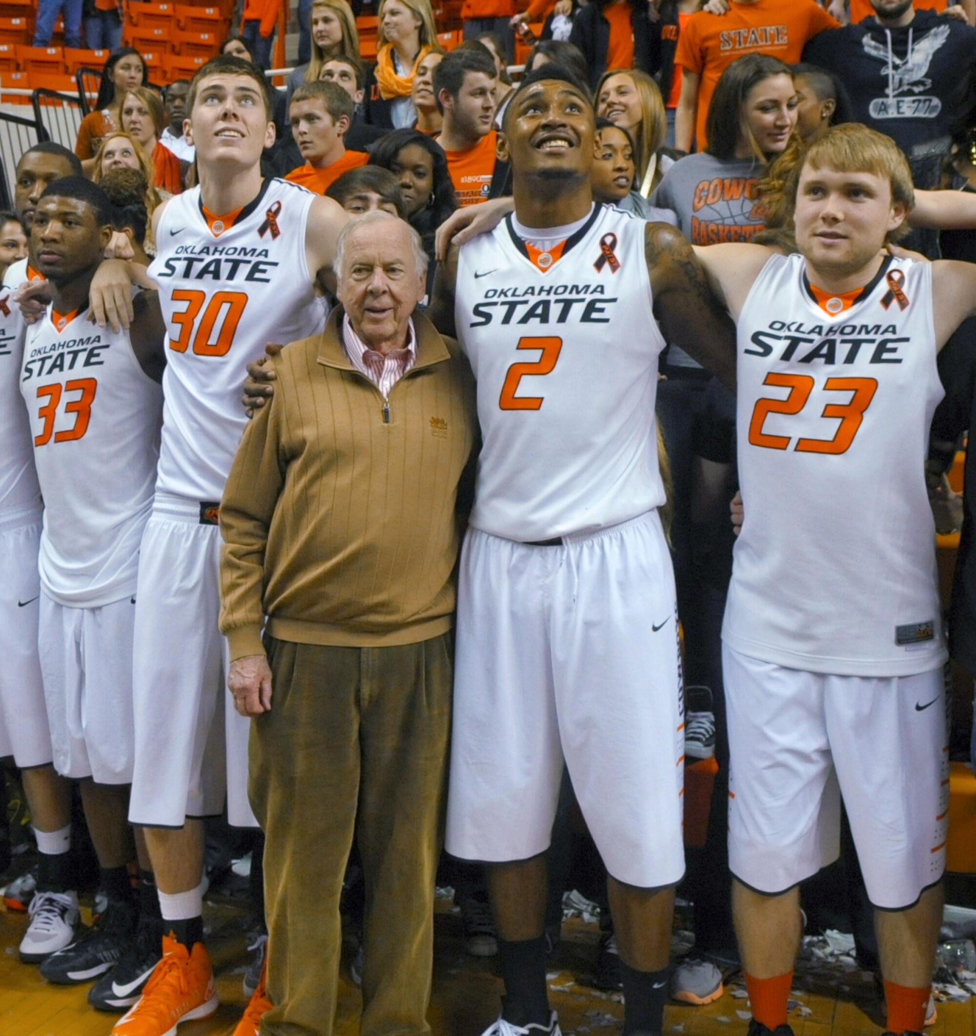 Oklahoma State supporter T. Boone Pickens celebrates with Marcus Smart, Mason Cox, Le'Bryan Nash and Alex Budke