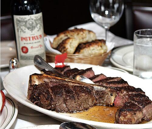 Steak for two, wine and fresh bread at Wolfgangs Zwiener's steakhouse in Beverly Hills.