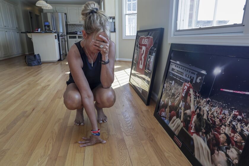 LAKE MURRAY, SOUTH CAROLINA, TUESDAY, AUGUST 13, 2019 -Kym Hilinski pauses as she details from the moment the photo, right, was taken of her son, Tyler, after he led the Washington State Huskies to a come from behind win over Boise State in 2017. Tyler took his own life at his Pullman apartment in January, 2018. (Robert Gauthier/Los Angeles Times)