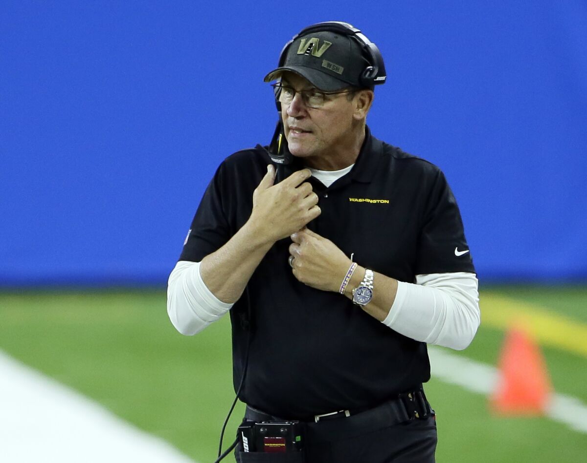 FILE - In this Nov. 15, 2020, file photo, Washington Football Team head coach Ron Rivera watches against the Detroit Lions during the second half of an NFL football game in Detroit. The mess for a franchise that finally dropped a nickname considered racist also has included harassment claims from former club employees and reporters, and a battle over minority ownership stakes. Those are beyond Rivera's reach, but as he recalled about a phone call just after he was fired by the Panthers last December with Washington team owner Daniel Snyder, Rivera's charge was more than what happens between the sidelines. (AP Photo/Duane Burleson, File)