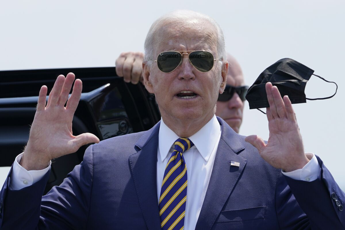 President Biden holds up a face mask 