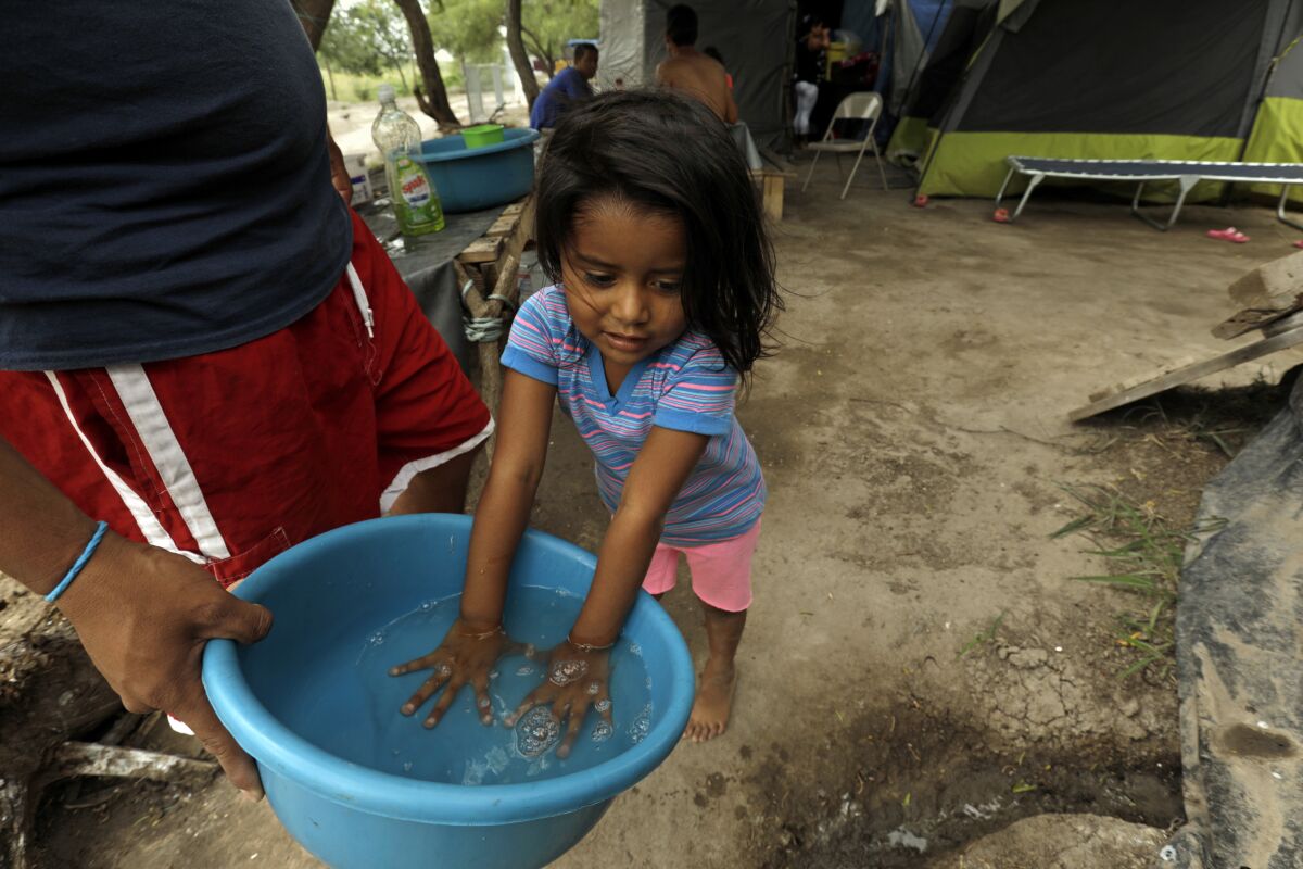 Migrants wash their clothes at the Matamoros refugee camp.