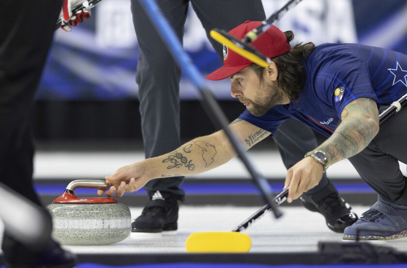 Team Shuster's Chris Plys casts the rock while competing against Team Persinger at the U.S. Olympic Curling Team Trials at Baxter Arena in Omaha, Neb., Wednesday, Nov. 17, 2021. (AP Photo/Rebecca S. Gratz)