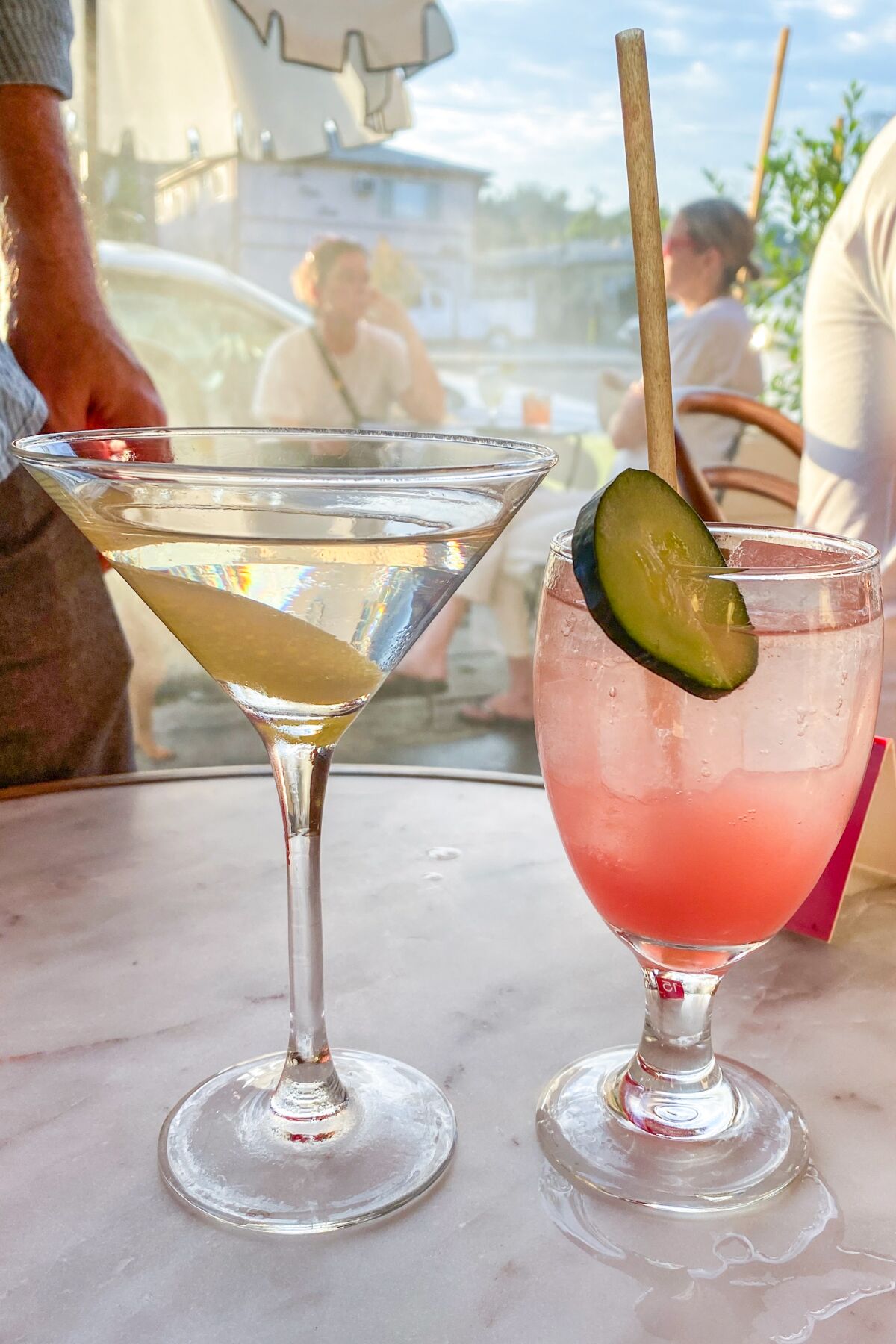Two cocktails on an outdoor table