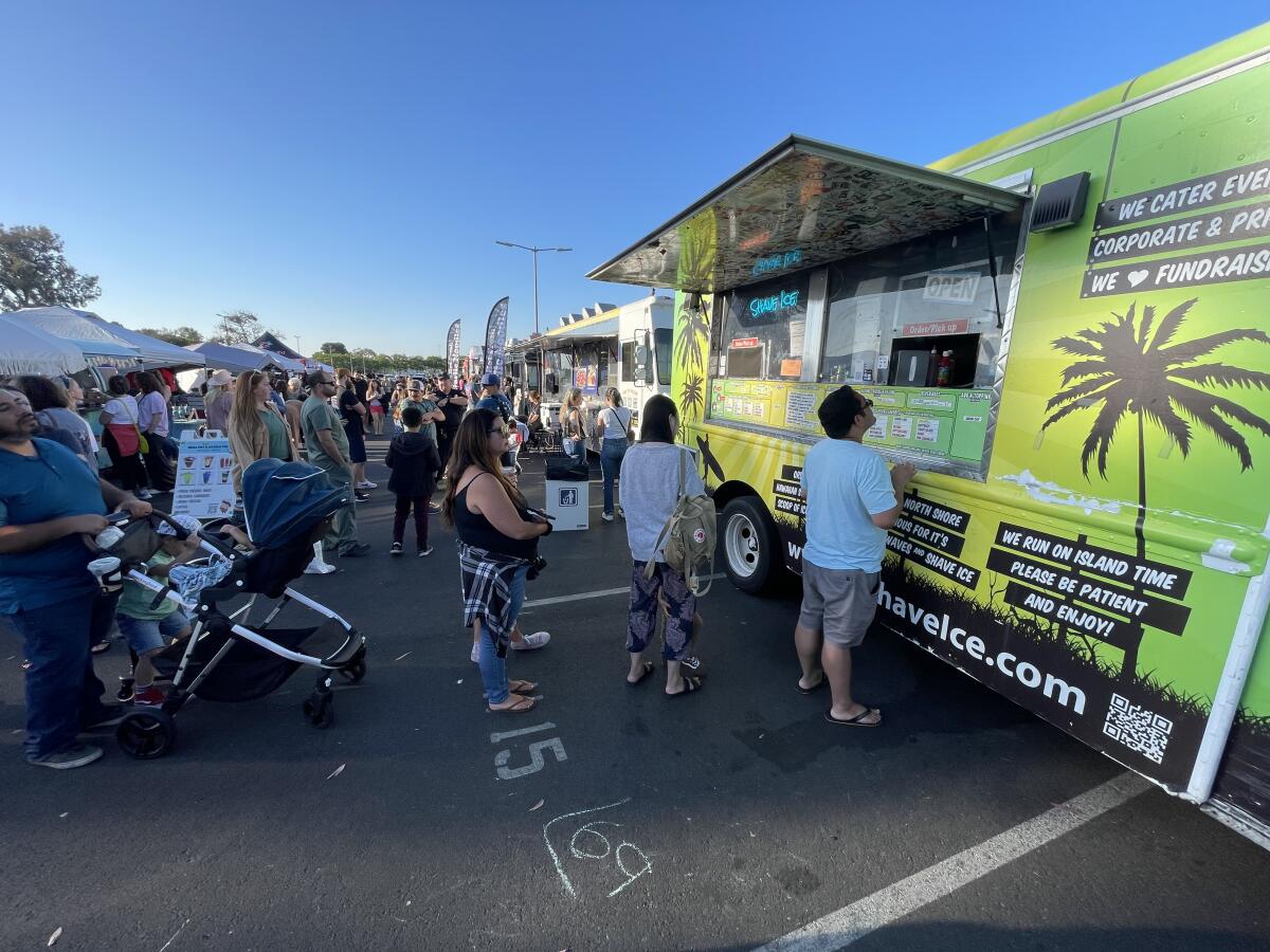 The H.B. Shave Ice truck serves customers at the Weekend Night Market in Huntington Beach.