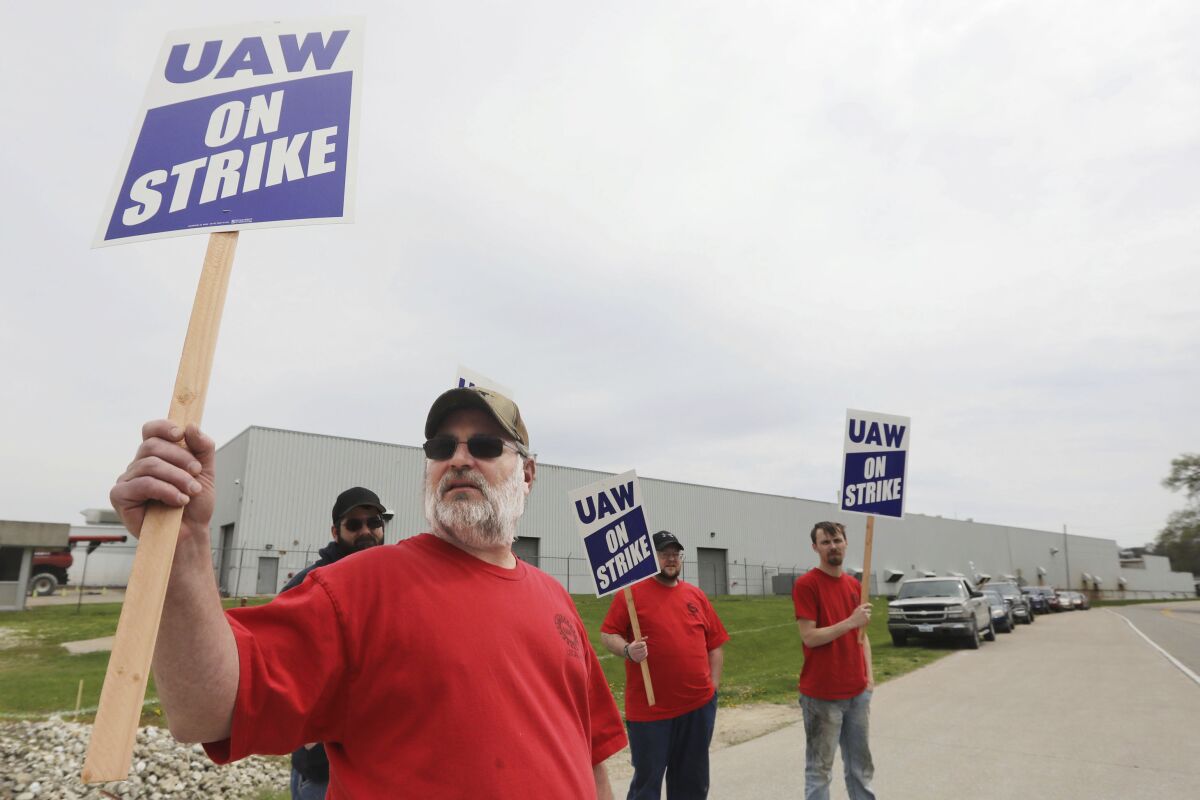 FILE - Members of United Auto Workers Local 807 picket after going on strike, Monday May 2, 2022, at a CNH plant in Burlington, Iowa. In June 2022, a group of U.S. senators led by Vermont independent Bernie Sanders is lending its support to workers at two CNH Industrial plants who have been on strike for better pay and benefits for more than a month. (John Loveretta/The Hawk Eye via AP, File)
