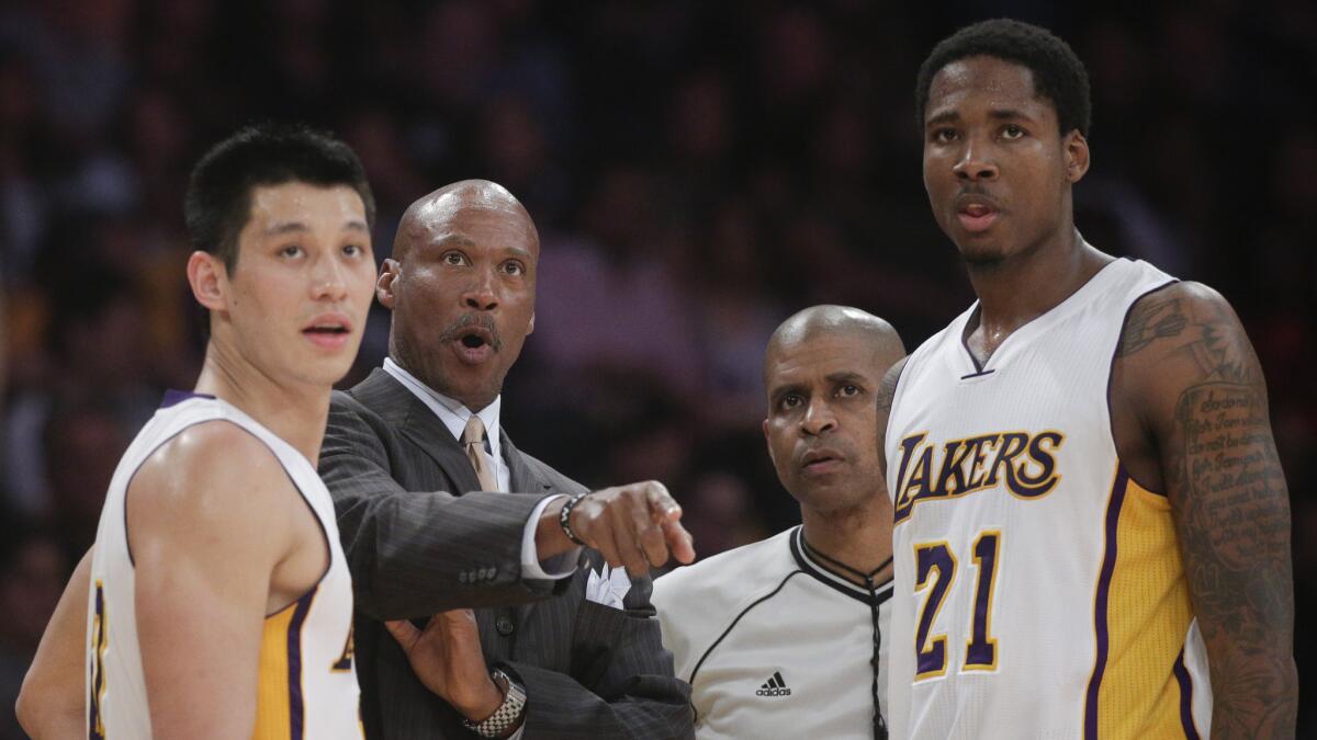 Lakers Coach Byron Scott speaks with players Jeremy Lin, left, and Ed Davis during Sunday's 101-87 win over the Philadelphia 76ers at Staples Center.