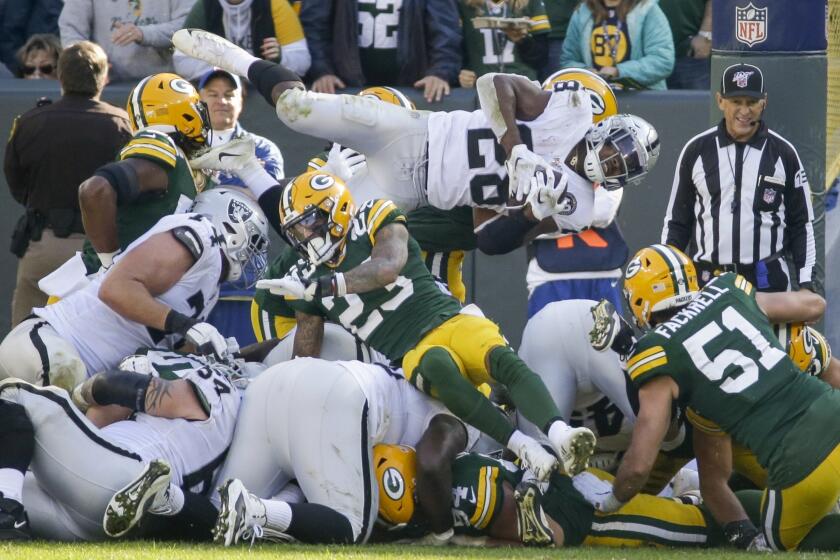 Oakland Raiders' Josh Jacobs is stopped on a fourth down run during the second half of an NFL football game against the Green Bay Packers Sunday, Oct. 20, 2019, in Green Bay, Wis. (AP Photo/Mike Roemer)