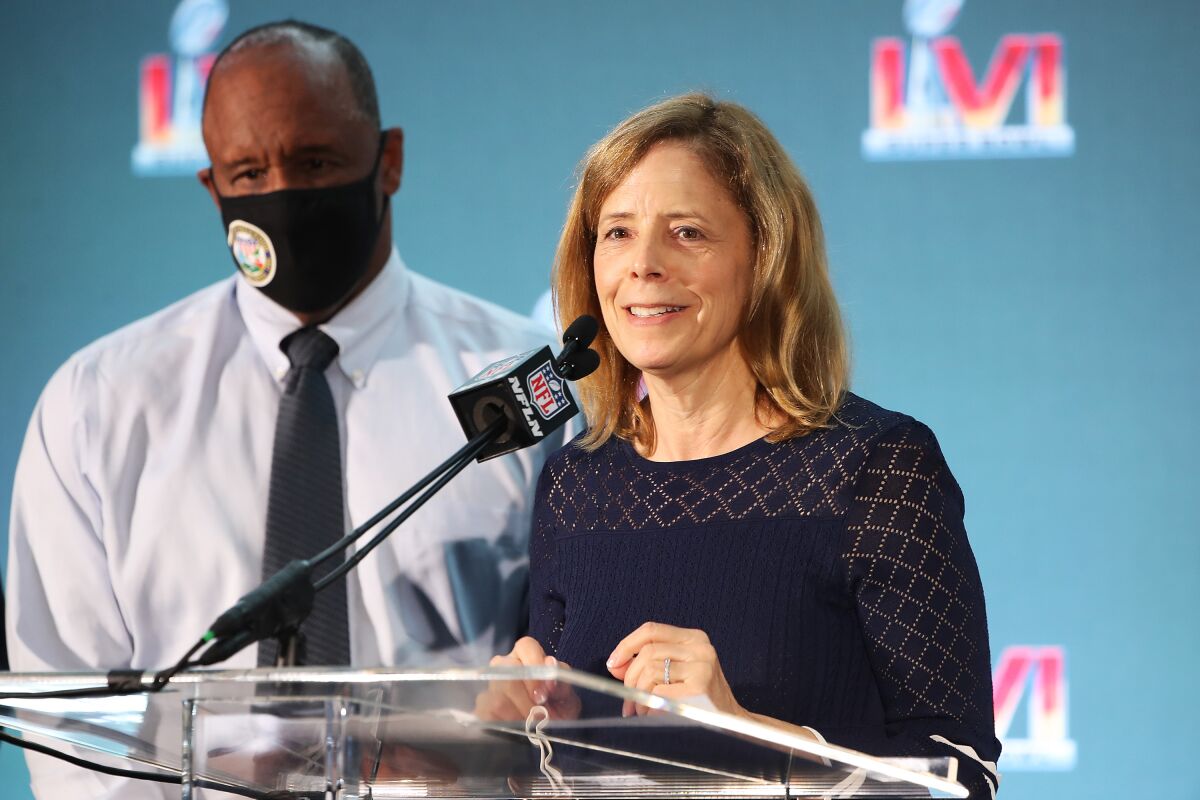 A man and a woman stand at a lectern.