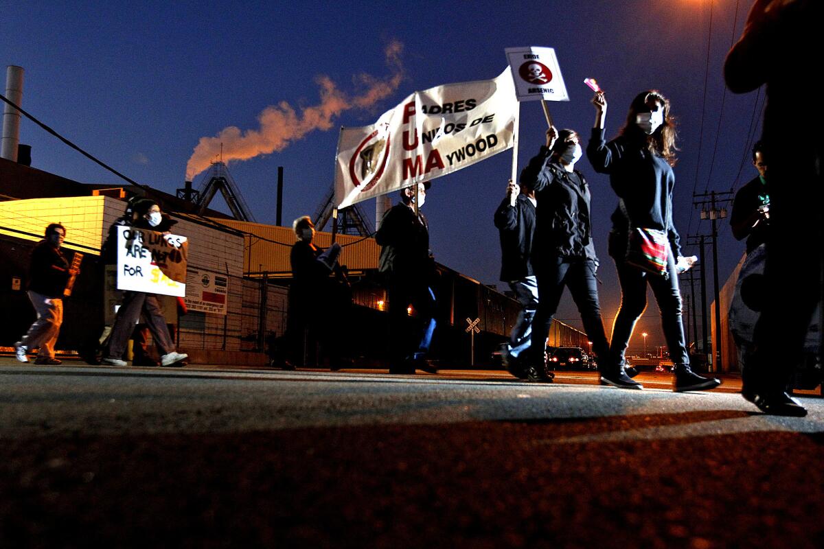 Protesters wear face masks during a rally outside of Exide Technologies in Vernon, which has been cited frequently for excessive lead emissions.