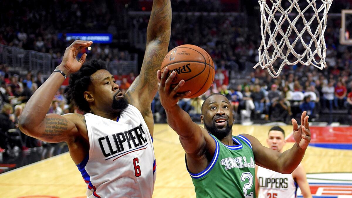 Clippers center DeAndre Jordan looks to block a layup by former Mavericks guard Raymond Felton during the first half on April 10.